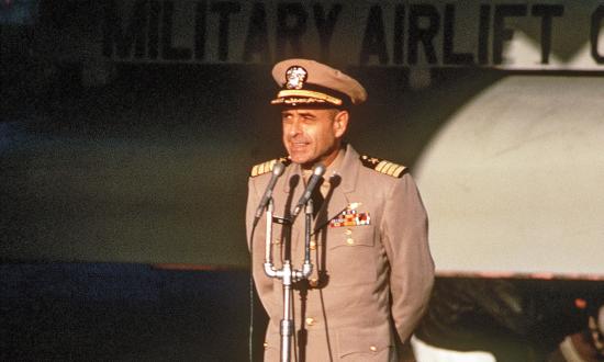 Captain Jeremiah Denton delivering remarks at Clark Air Base, Philippines, in February 1973 in front of a C-141 Starlifter aircraft